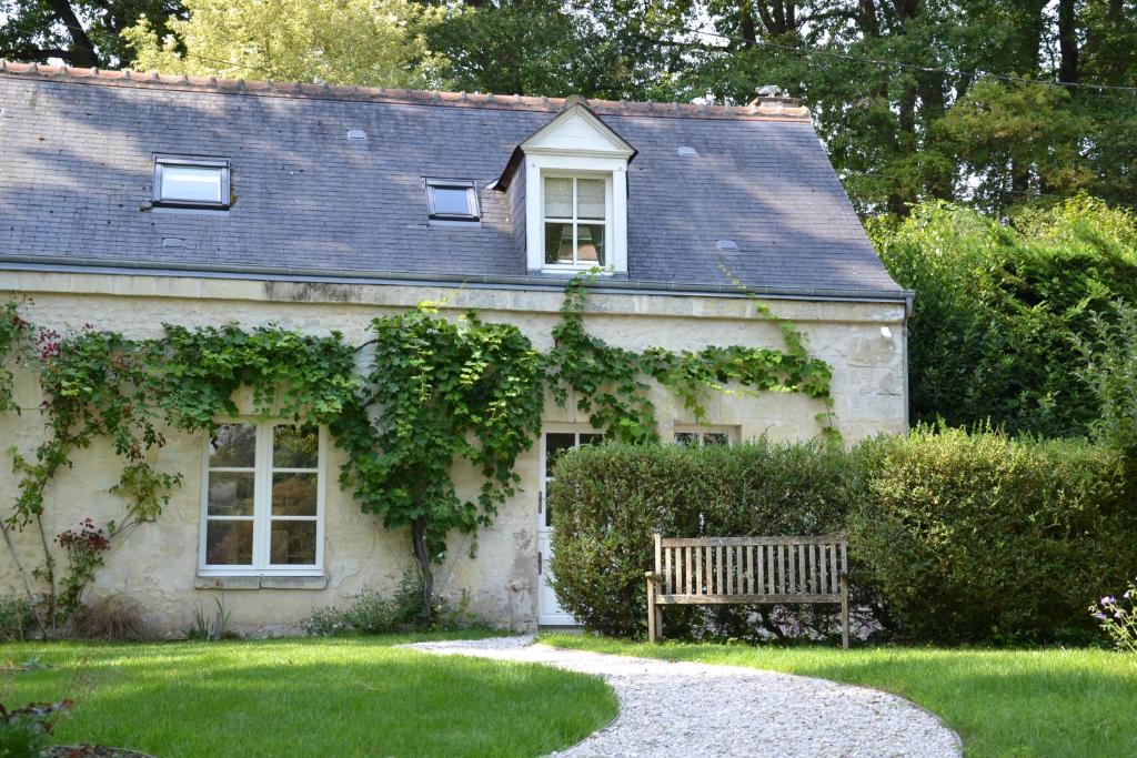 une maison avec un banc devant elle dans l'établissement Le Pavillon de la Lanterne, à Rochecorbon