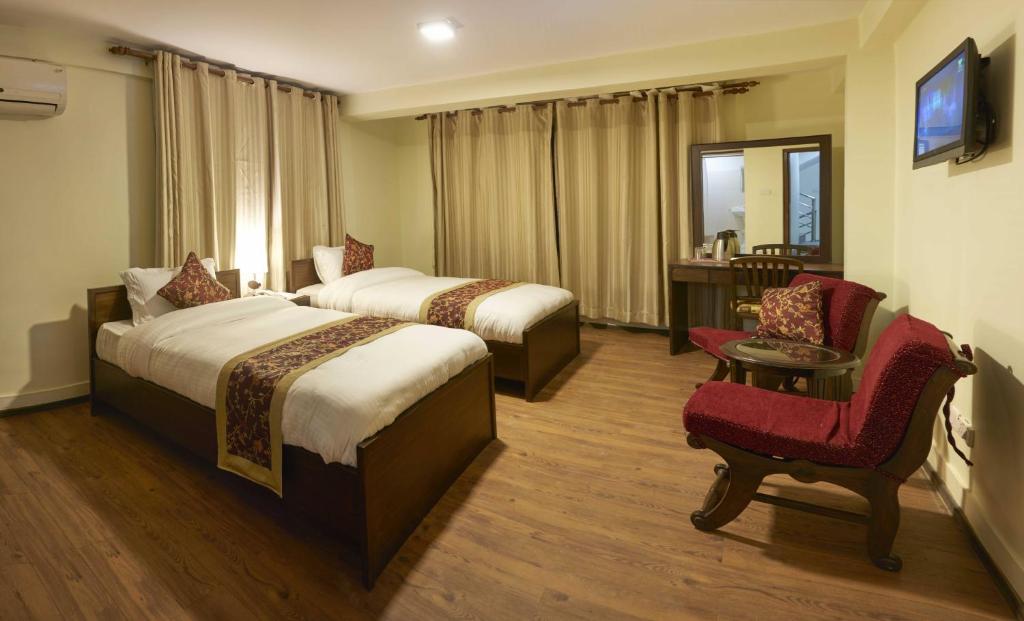 Postel nebo postele na pokoji v ubytování Hotel Yambu kathmandu