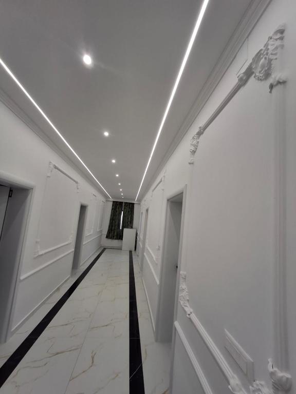 a hallway with white walls and a white ceiling at Hotel Bar Restorant RRAHIMI in Shënmëri