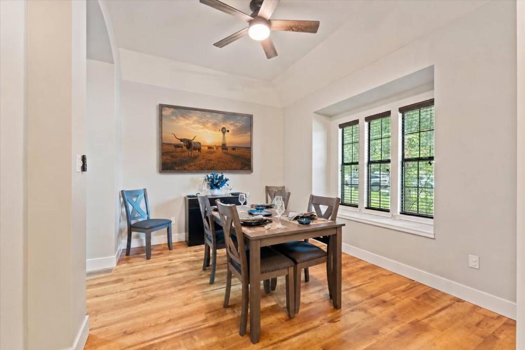 a dining room with a table and chairs and a ceiling fan at Pines and Patio Hideaway in Conroe