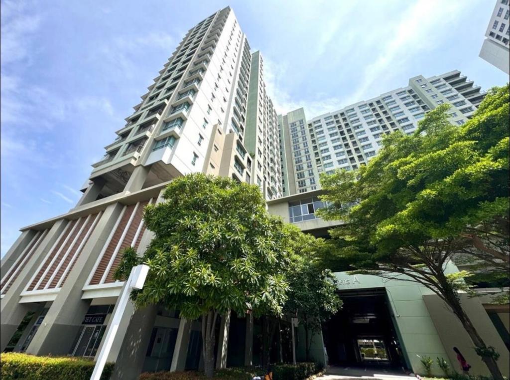 a tall white building with a tree in front of it at lumpini naklua wongamat in North Pattaya