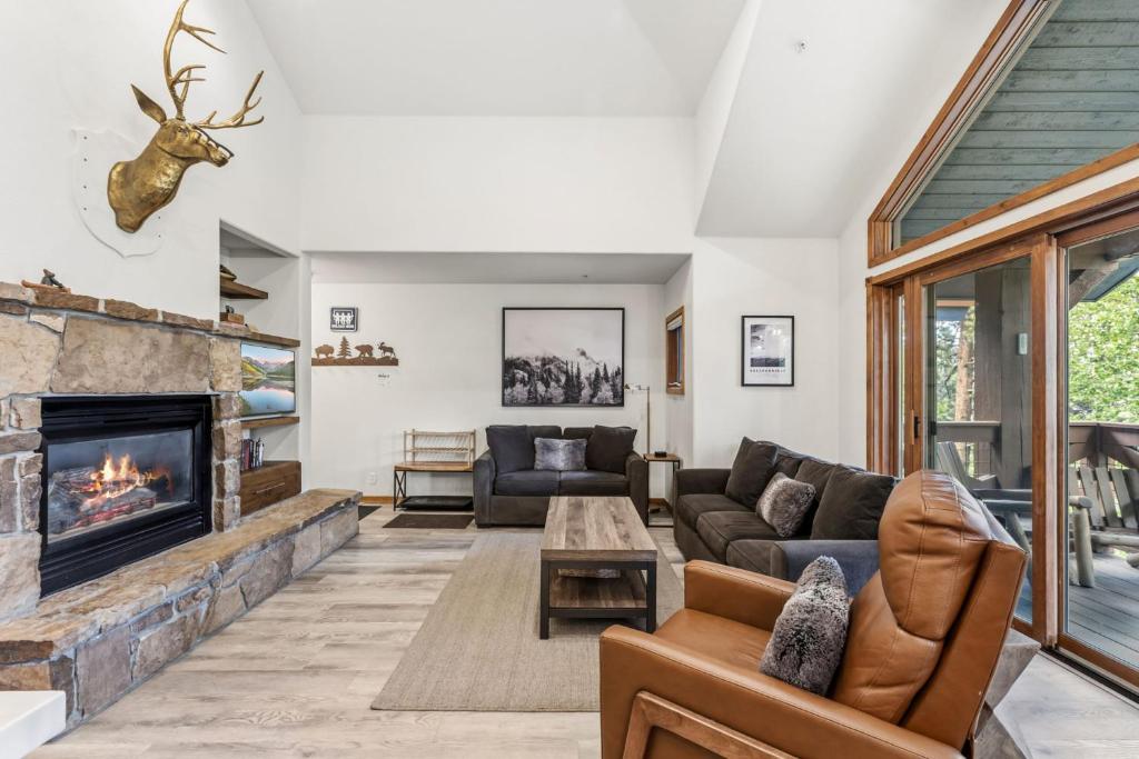 a living room with a couch and a fireplace at Los Pinos 22C by Great Western Lodging in Breckenridge