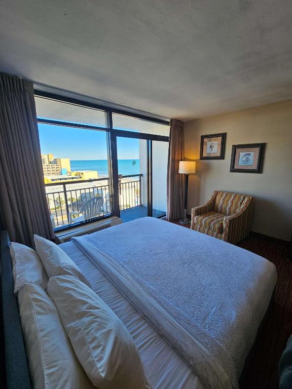 a hotel room with a bed and a large window at Oceanview Room at Landmark Resort in Myrtle Beach