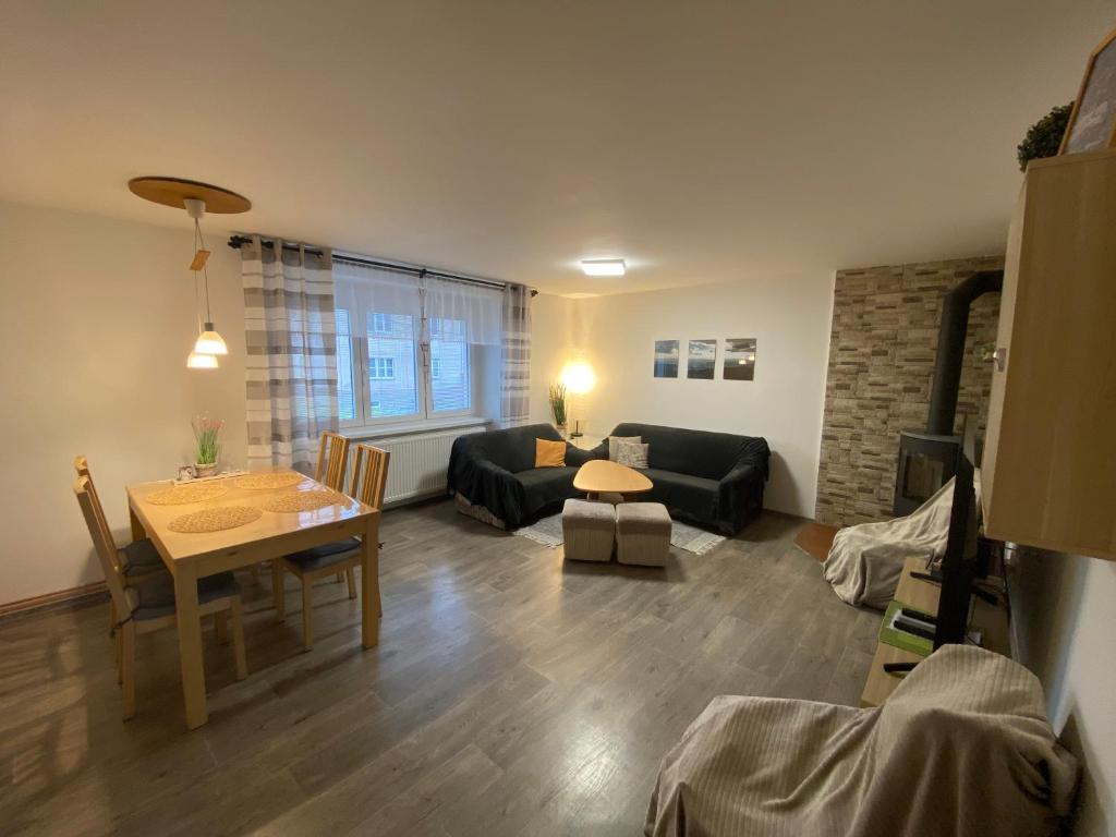 a living room with a couch and a table at Apartmán U Jiroutů in Rokytnice v Orlických Horách