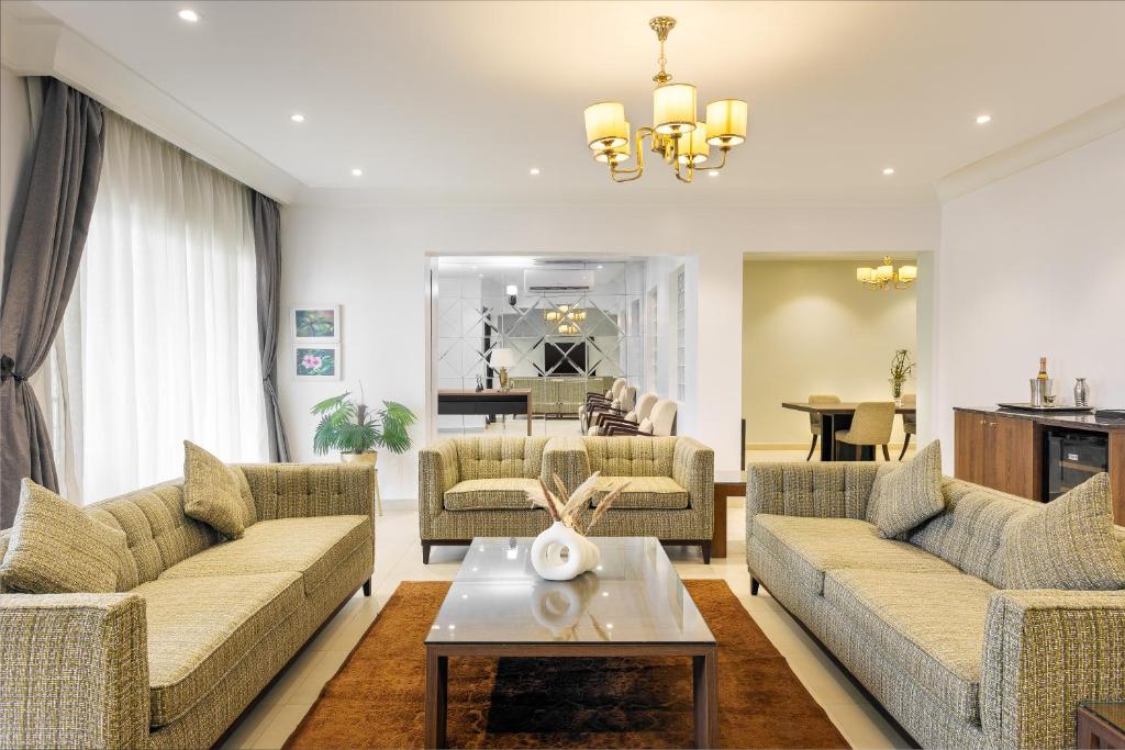 a living room with two couches and a table at Metro Apartments in Lagos