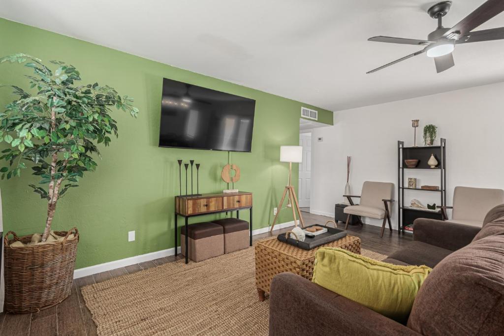 a living room with a couch and a flat screen tv at RUDRASAI 2611-Tempe,AZ in Tempe