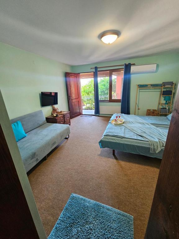 a bedroom with two beds and a mirror at Regina's Guesthouse in Balchik