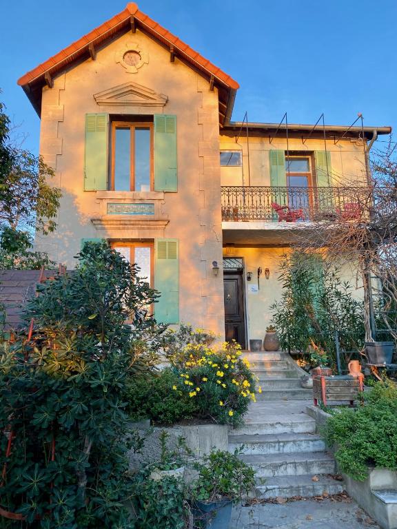 an old house with stairs in front of it at QG Marseille in Marseille