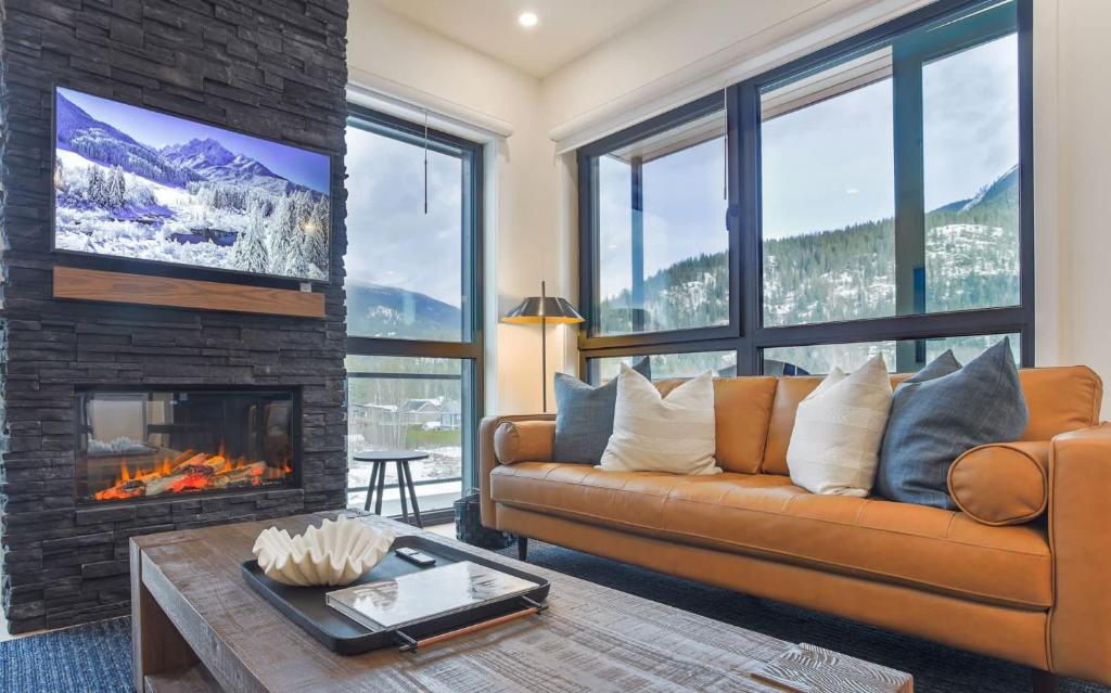 a living room with a couch and a fireplace at The View - Luxury Penthouse Condo in Revelstoke