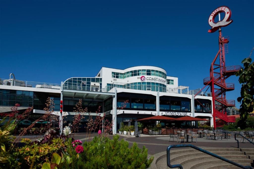 a large building with a sign in front of it at Coast Lonsdale Quay Hotel in North Vancouver