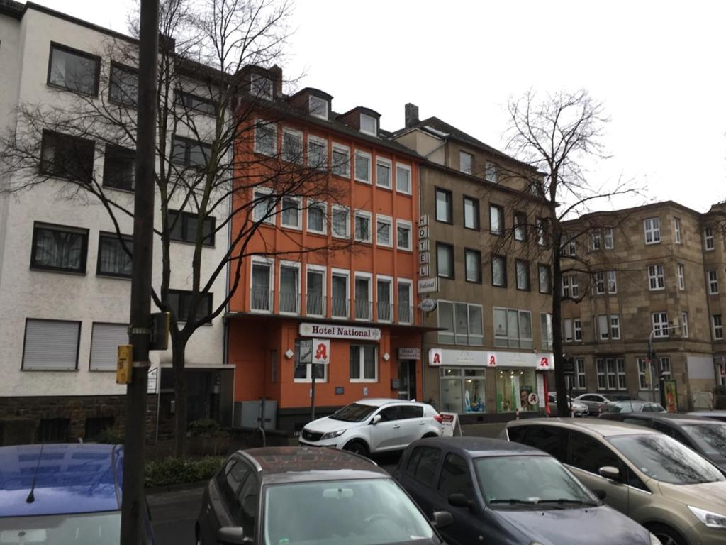 a street with cars parked in front of buildings at Hotel National in Koblenz