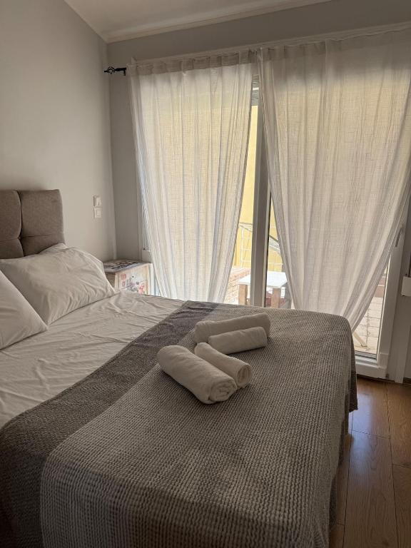 a bedroom with a bed with two towels on it at Tiny Diamond in Plomari