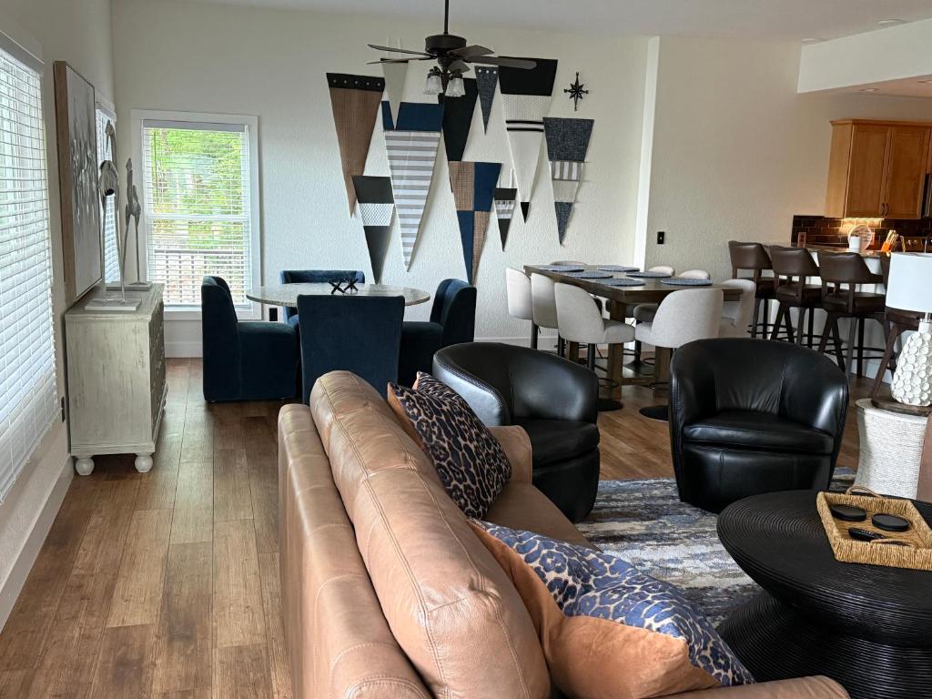 a living room with a couch and chairs and tables at Lakefront Villa with Dock Swim Platform in Lake Ozark
