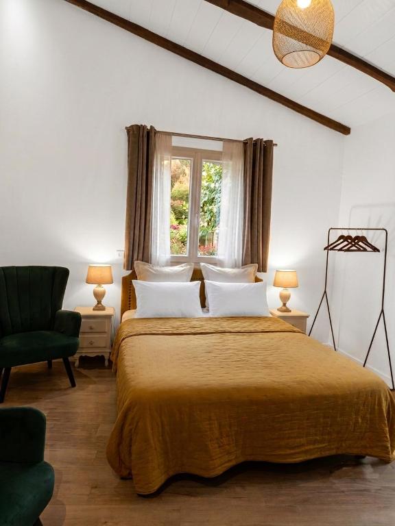 a bedroom with a large bed and a window at La Bastide des Mûriers in Deaux