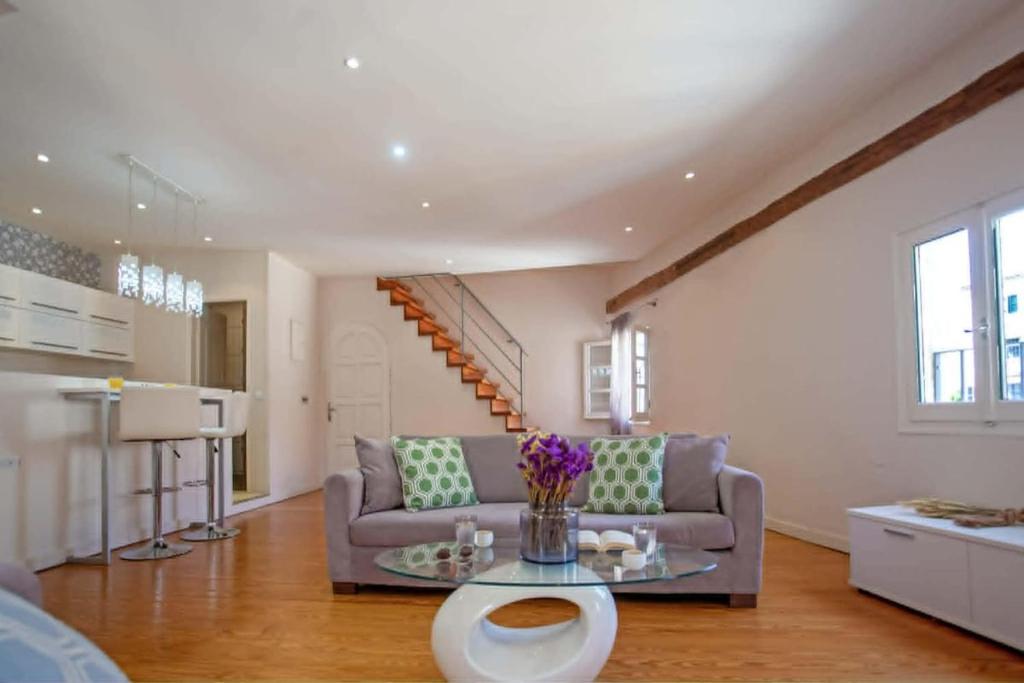 a living room with a couch and a table at Guilford Loft in Corfu