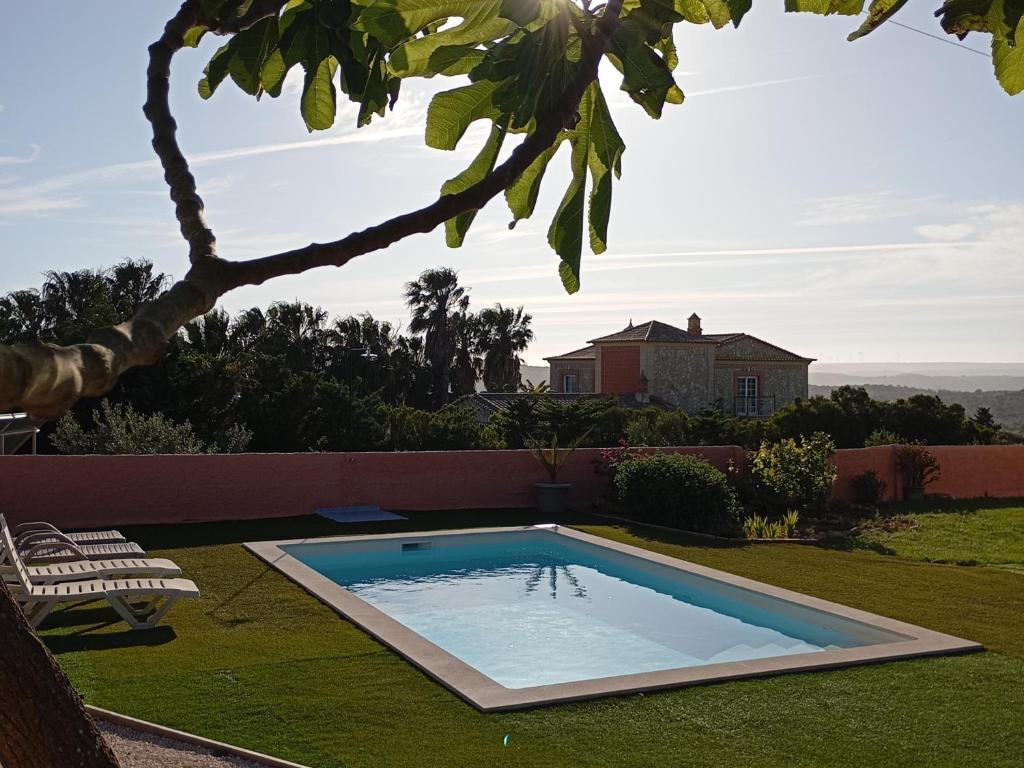 a swimming pool in the yard of a house at Monte Rio House in Luz