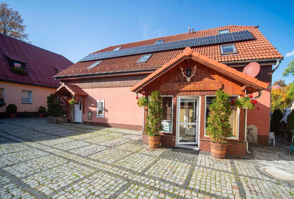 a house with solar panels on the roof at Sobiesz - Pokoje Gościnne in Jagniątków