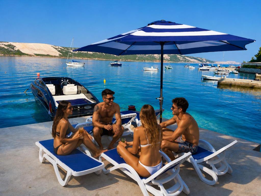 a group of people sitting on beach chairs under an umbrella at Villa Olivija-in front of beach! in Stara Novalja