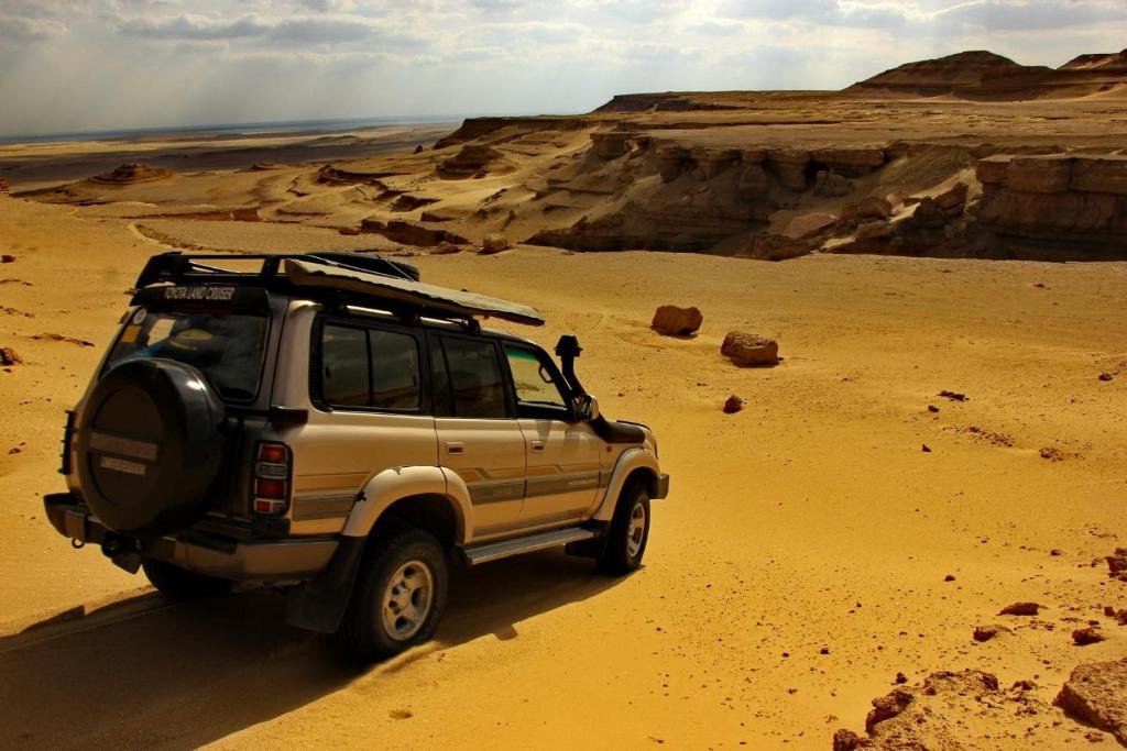 a jeep driving in the desert at Safarova Tours in Fayoum
