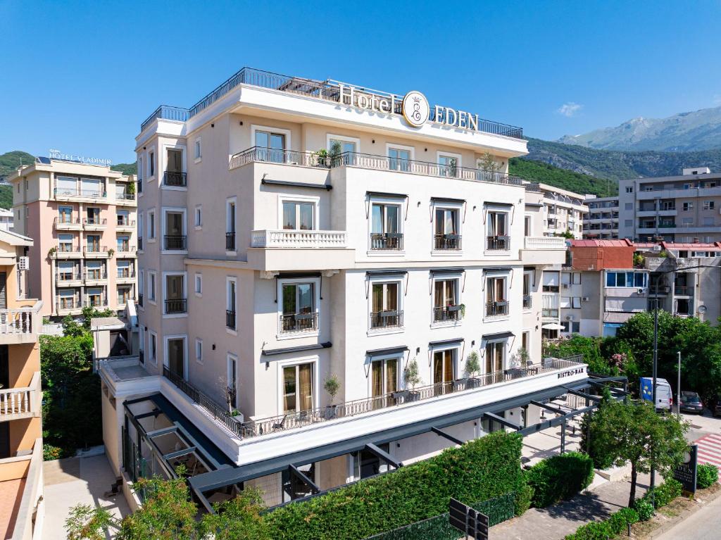 a large white building with a sign on it at Hotel Eden in Budva