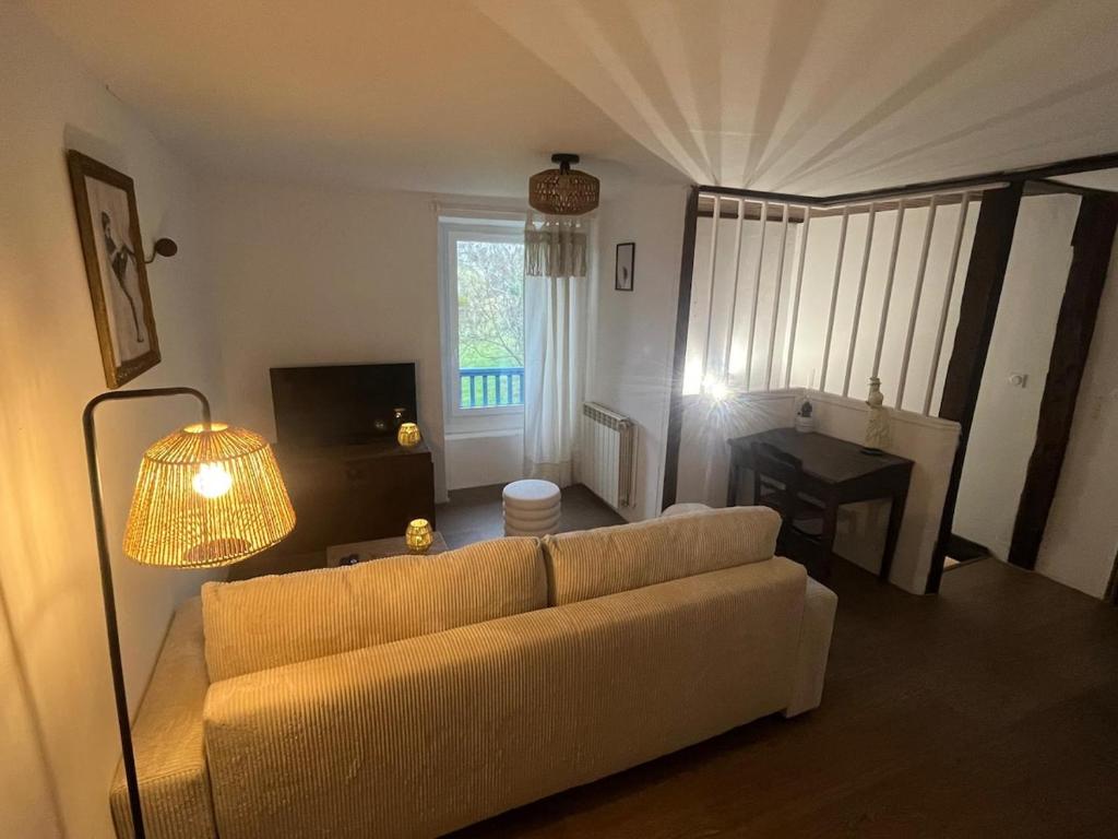 a living room with a couch and a table at Le Gîte Chez Mémé in Lavelanet