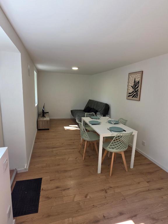 a living room with a table and chairs and a couch at T2 proche gare & centre ville climatisé in Castres
