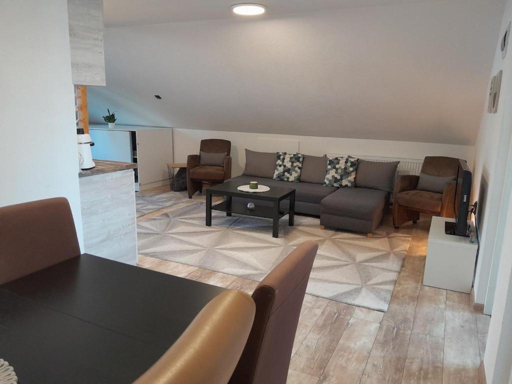 a living room with a couch and a table at Bara Apartment and Studio in Gheorgheni