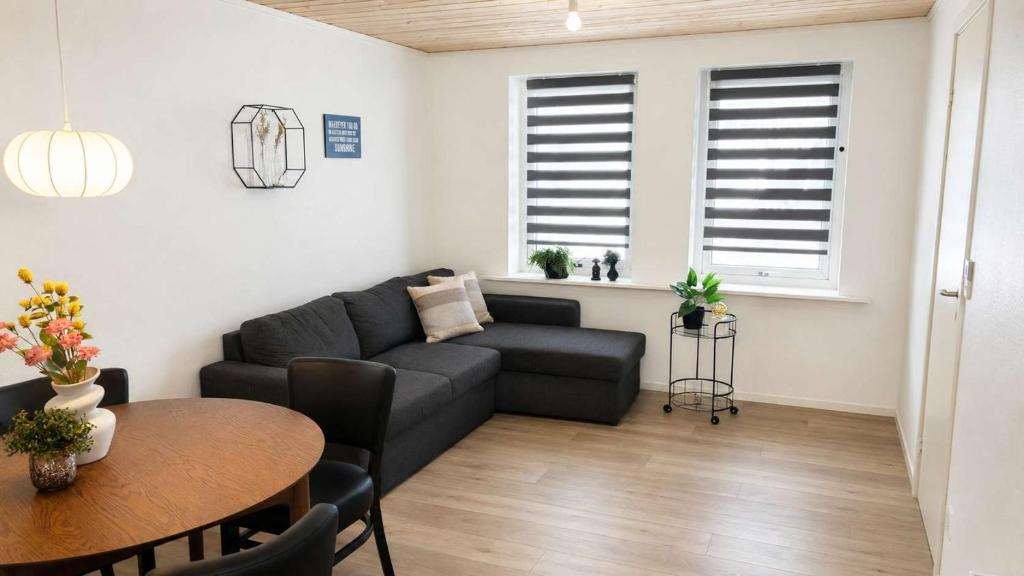 a living room with a couch and a table at Klaksvik Mountain View Stay in Klaksvík