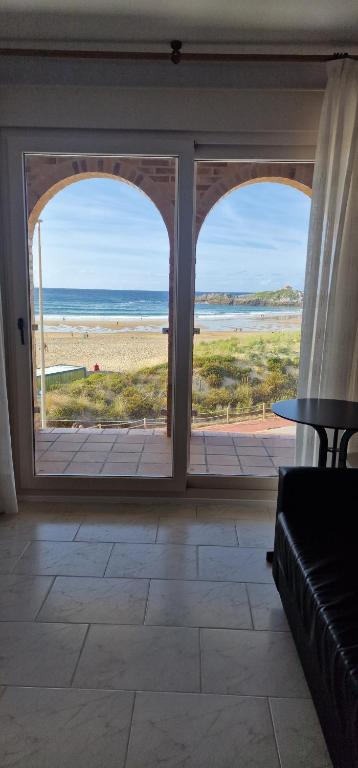 an open living room with a view of the beach at Apartamentos Regollera in Noja
