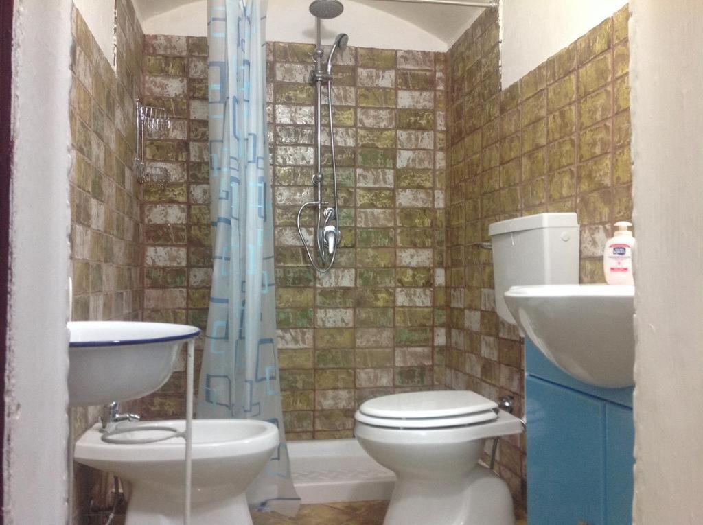 a bathroom with a toilet and a sink and a shower at Casa Vacanze Gerardo in Mottola
