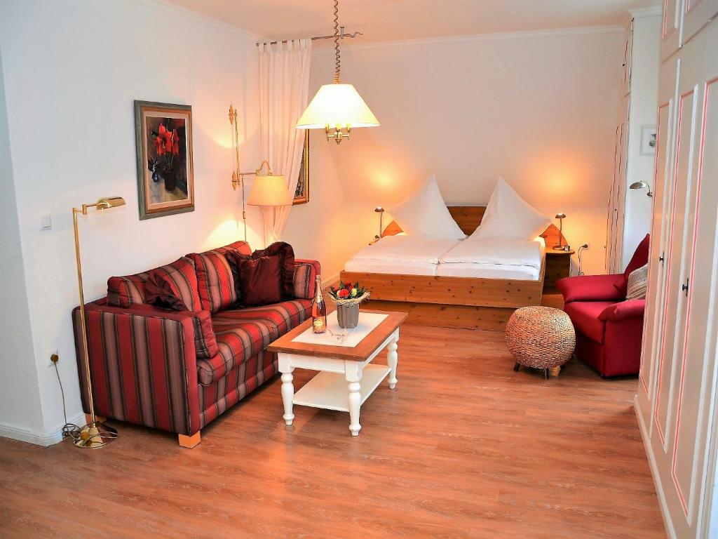 a living room with a couch and a bed at Haus Seeflieger in Westerland