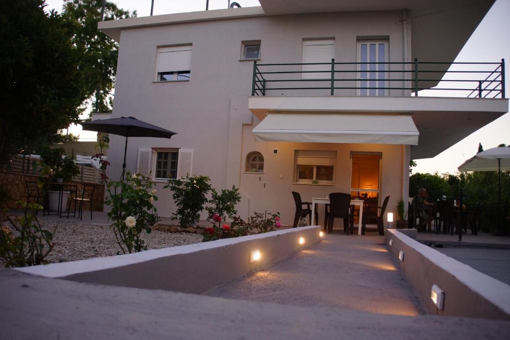 a house with a patio with a table and chairs at Captain's House in Filiatra