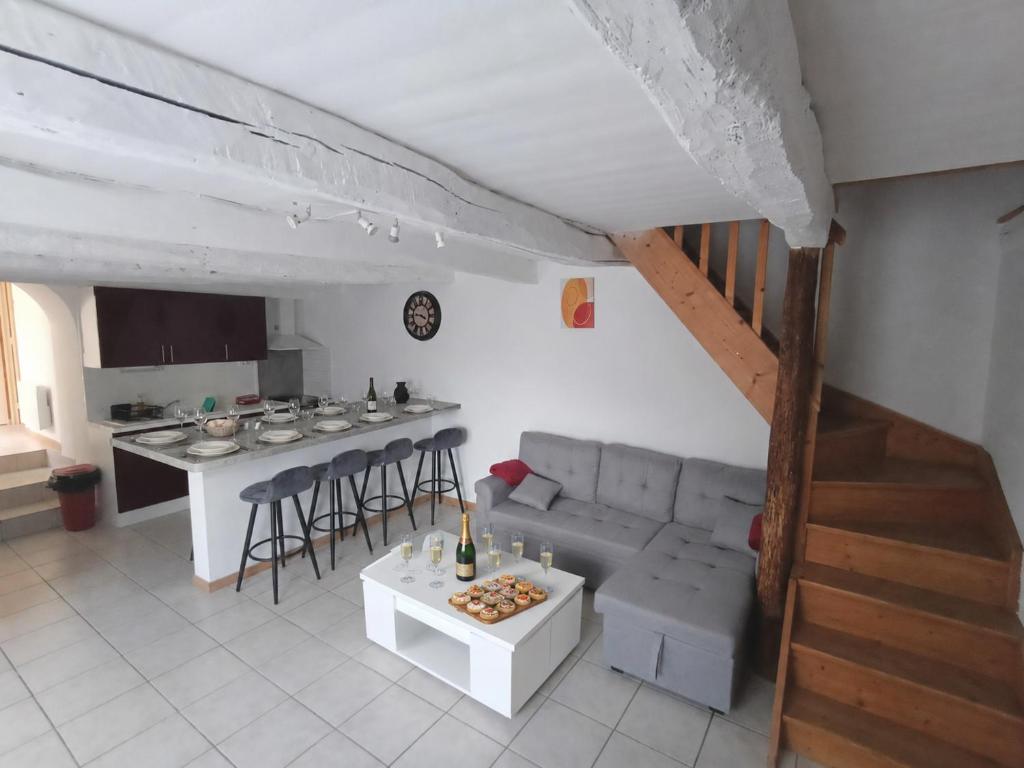 a living room with a couch and a table at Gîte ô scope-2km du futuroscope- linges et ménage inclus in Jaunay-Clan