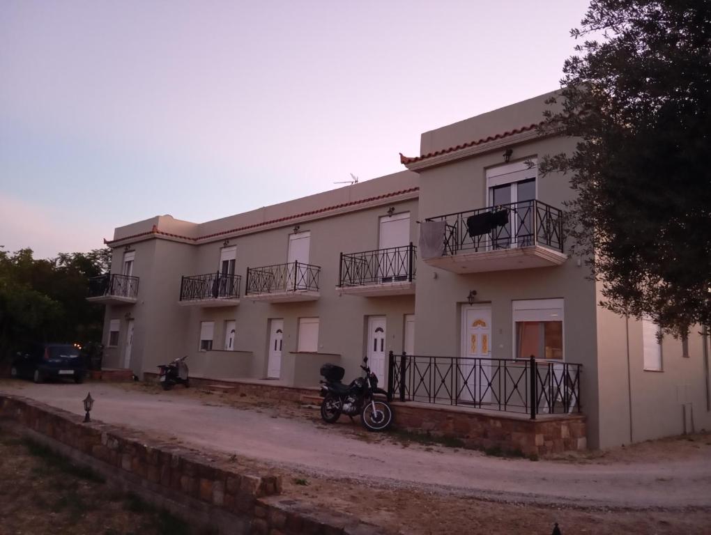 a building with a motorcycle parked in front of it at Amentas Luxury Apartments in Vrontádos