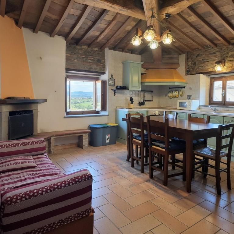 a kitchen with a table and chairs in a room at Rustic Refuge in the Hills in Santa Luce