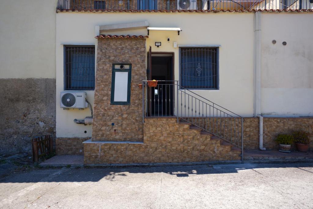 a brick building with a door and a staircase at La Parentesi in Salerno