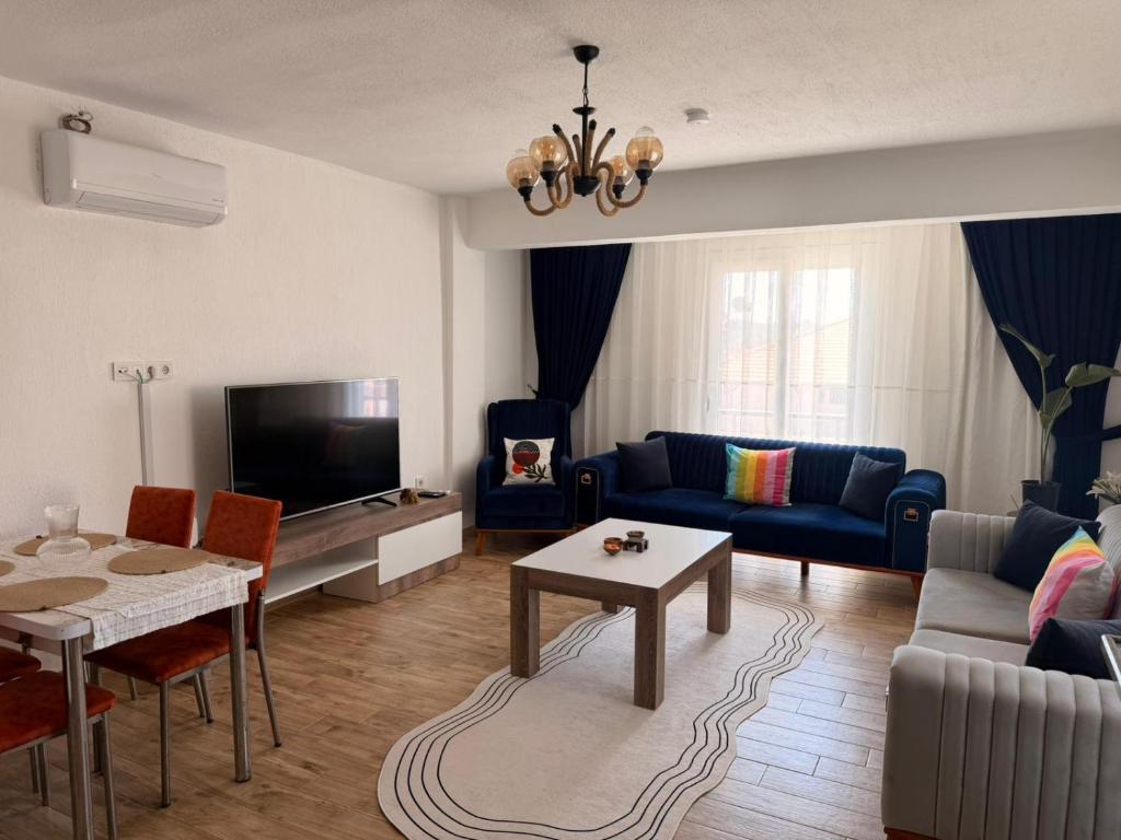 a living room with a couch and a table at Olivra Apart in Cedit