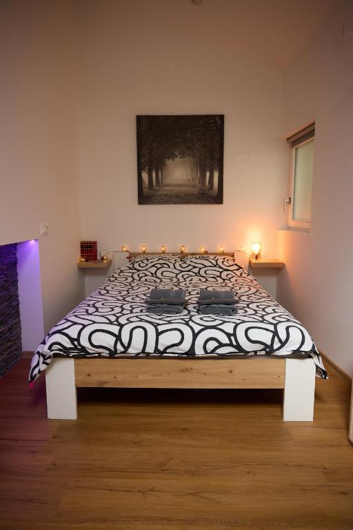 a bedroom with a bed with a black and white comforter at Starview by MD apartments in Ljubljana