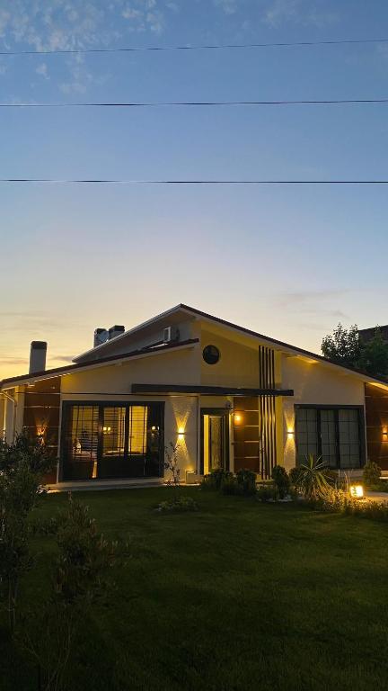 a large house with a lawn in front of it at Villa suit in Trabzon