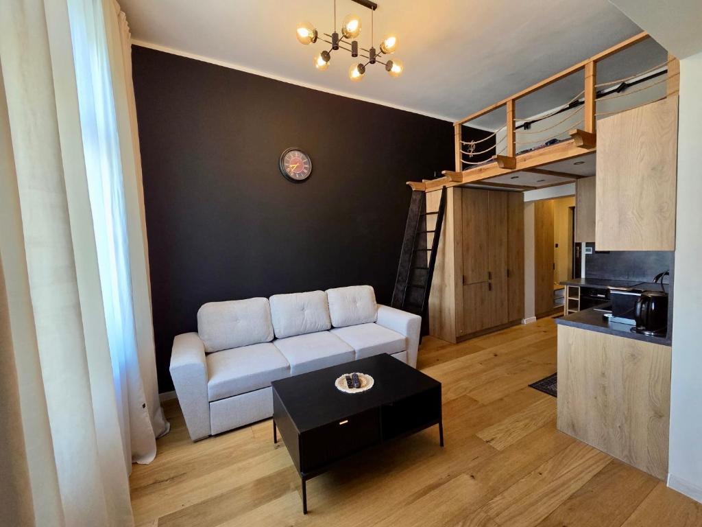 a living room with a couch and a coffee table at Justinrent 1 in Legnica
