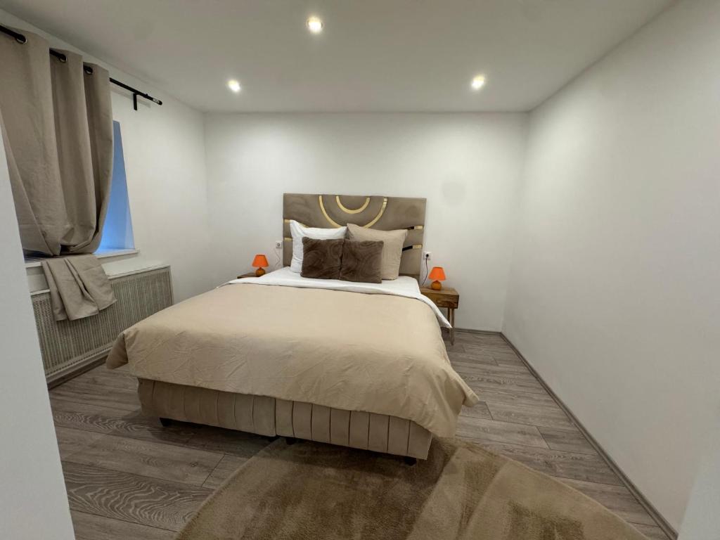 a bedroom with a large bed in a white room at Eliasar1 in Linz