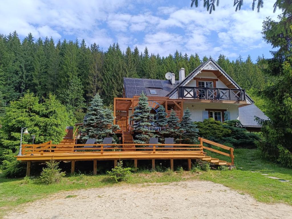 a house with a large deck in front of it at Dom Prowansalski in Jaworzynka