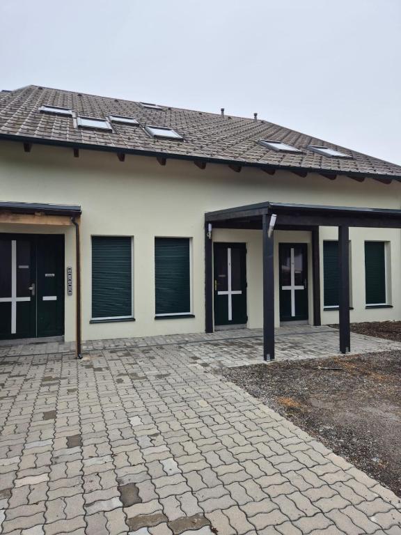 a house with a brick driveway in front of it at Comfort Collection Waldviertel in Litschau