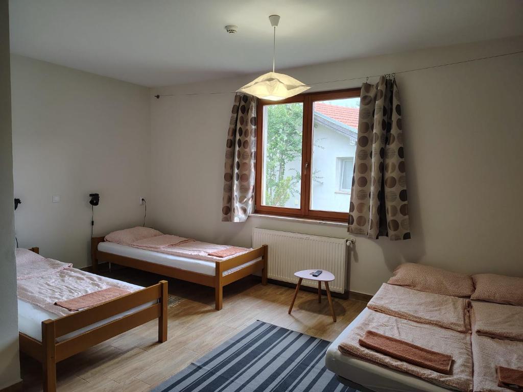 a room with two beds and a window at Kentaur Guesthouse in Atea