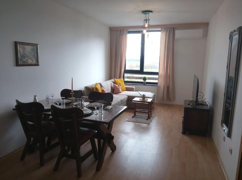 a living room with a table and a couch at Mountain Nest Pirin in Razlog