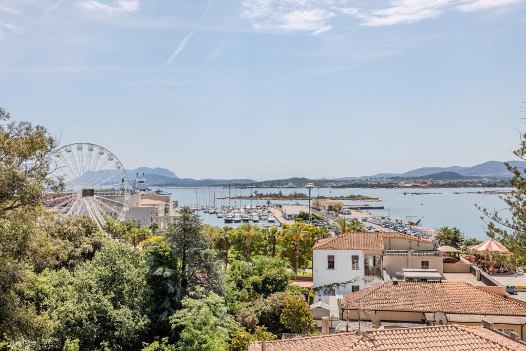 a view of a harbor with a ferris wheel at Antares Rooms and Suites in Olbia