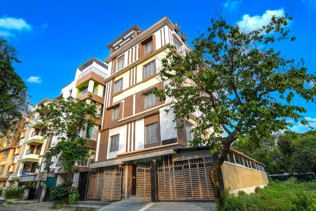 an apartment building with a tree in front of it at The Fortune Hotel, Newtown in New Town
