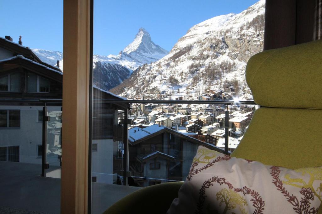 a room with a view of a snowy mountain at Hörnligrat Apartments in Zermatt