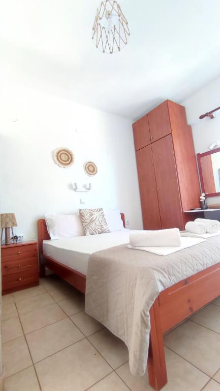 a bedroom with two beds and a dresser at Villa Christina Sea Side B in Hanioti