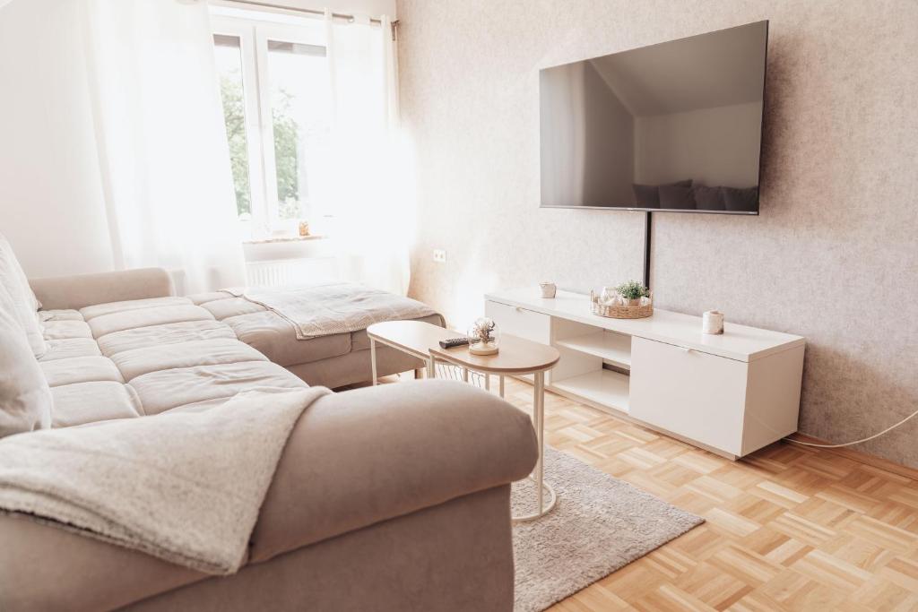 a living room with a couch and a tv at Ferienwohnung Düring in Loxstedt